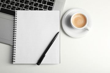 Empty  notebook on laptop keyboard, on light background
