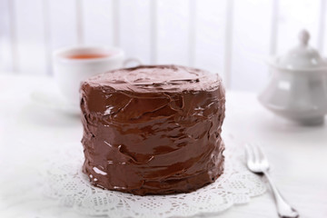 Tasty chocolate cake on light background