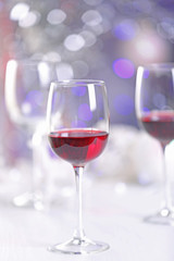 Wineglasses on blurred lights background