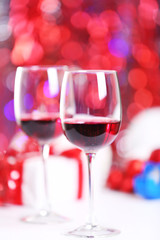 Wineglasses on red blurred lights background