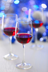 Wineglasses on blue blurred lights background