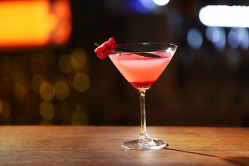 Glass of cocktail on bar background