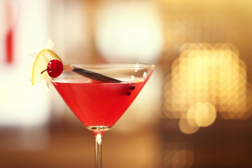 Glass of cocktail on bar background