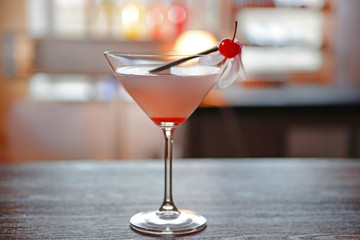 Glass of cocktail on bar background