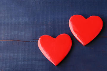 Wooden hearts on color wooden background