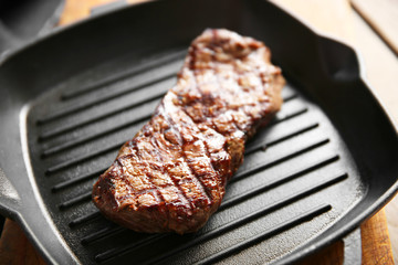 Grilled steak on grill pan, closeup
