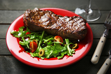 Grilled steak with vegetable salad, closeup