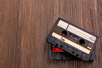 Old audio cassettes on wooden background