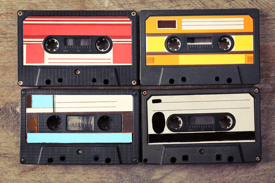 Group of retro cassettes on wooden table, closeup
