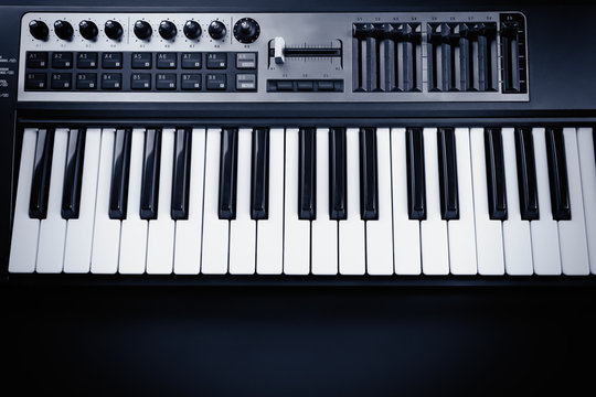 Keyboard of synthesizer on black background