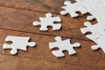 Incomplete puzzles on wooden table