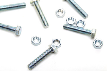 Bolts and nuts and washers on white paper
