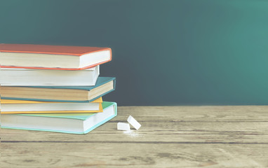 Few books with chalk on table