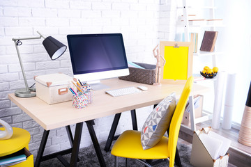 Modern room design. Stylish workplace by the wall.