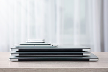 Stack of electronic device on wooden table