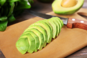 Fresh sliced avocado on cutting board, close up