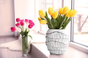 Beautiful fresh tulips on windowsill indoors