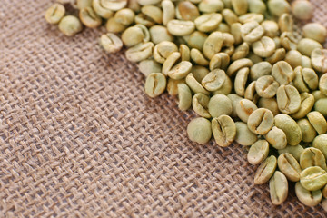 Green coffee beans on sackcloth