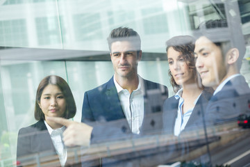 Group of business people discuss something inside office