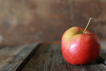 bitten apple on a wooden background