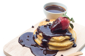 Pancakes with chocolate syrup and strawberry
