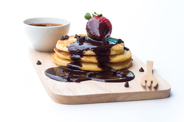 Pancakes with chocolate syrup and strawberry