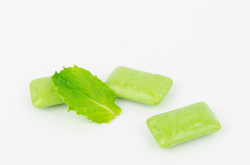 chewing gum with mint leaf on white background