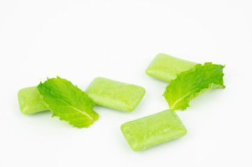 chewing gum with mint leaf on white background