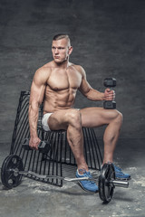 Fototapeta na wymiar Shirtless muscular man posing in studio.