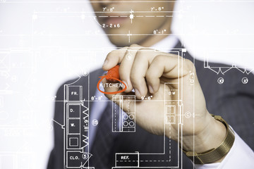 man drawing floor plan