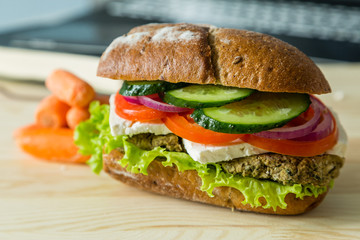 Vegan sandwich in lunch box with carrots and nuts