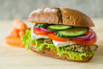 Vegan sandwich in lunch box with carrots and nuts