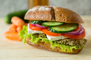 Vegan sandwich in lunch box with carrots and nuts