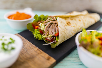 Tortilla with pulled pork, fresh vegetables