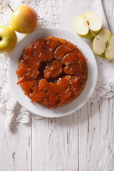Tarte Tatin with apples and caramel on a plate. Vertical top view 
