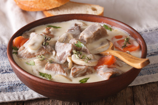 Veal with mushrooms in cream sauce in a bowl. horizontal
