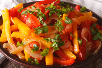 Stewed peppers with tomatoes and onions close up. horizontal
