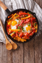 traditional Basque piperade with eggs close-up. vertical top view
