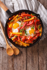 traditional Basque piperade with eggs close-up. vertical top view
