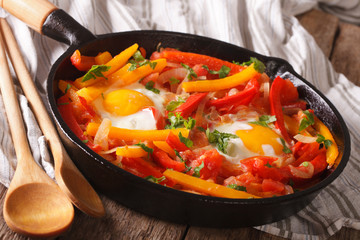 Spanish Food: pepper with fried egg in a pan close-up
