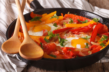 Basque breakfast: fried eggs with peppers close-up. horizontal
