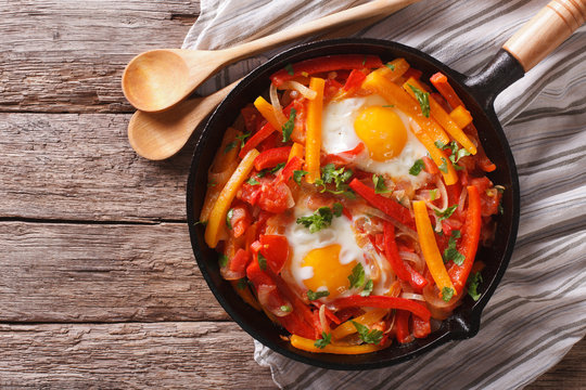 traditional Basque piperade with eggs close-up. horizontal top view
