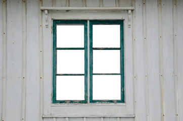 Fototapeta na wymiar Cut out windowpanes in an old window