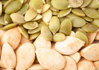 peeled pumpkin seeds or whole background macro