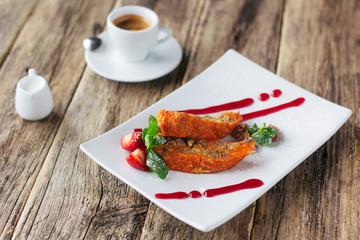 Vegetarian dessert. Carrot apple  sweet roll  with a strawberry sauce and a cup of espresso coffee served on wooden background. Lenten vegetarian desert from fruits.