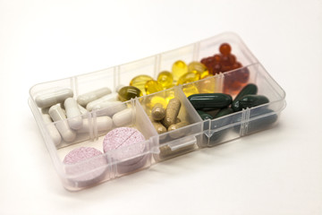 Different pills, medications, the pills in the box for drugs closeup on white background.