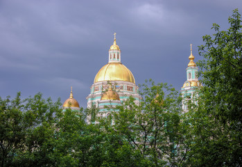 shining golden domes of  Epiphany Cathedral in Elokhovo before thunderstorm