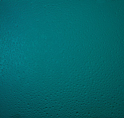 Drops on a glass in green