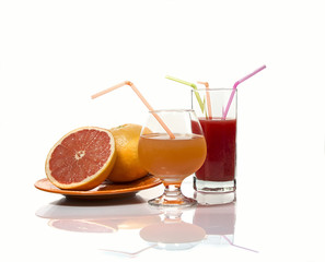 Grapefruits and grapefruit juice on a white gackground