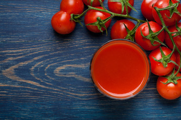 Fresh tomato juice on a blue background